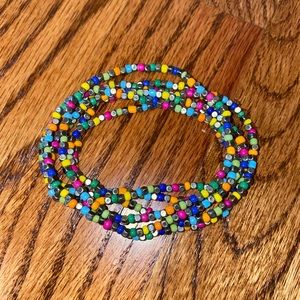 Set of 6 colorful beaded bracelets.